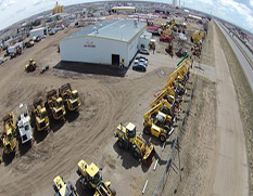 panoramic view of all machinery for sale in yard with shop