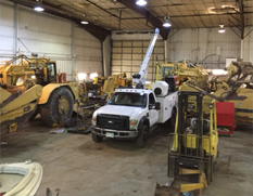 truck lift and machinery in front of the shop