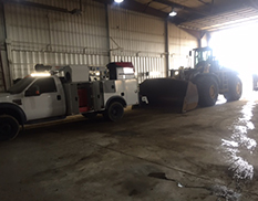 truck and machinery from side view in shop