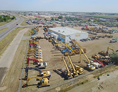 direct side view of prestige with store front and excvators and lifts