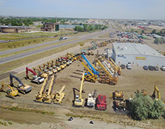 back and side view of store and yard with all equipment
