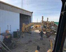 construction equipment/attachment in front of shop