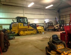 outside yard with construction machinery line up, lifts and loaders