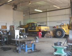 picture of the shop doors with equipment in shop