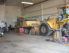 In shop: lawn and garden equipment, construction equipment, skid steer
